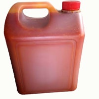a jug of brown sauce with a red lid