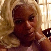 a woman with long blonde hair sitting at a table