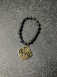 a bracelet with a shamanic symbol on it