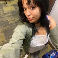 a woman is taking a selfie in a hallway