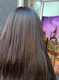 back view of a woman with long brown hair
