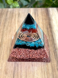 a glass pyramid with copper and turquoise