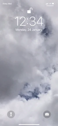 a screen shot of an iphone showing clouds and a clock