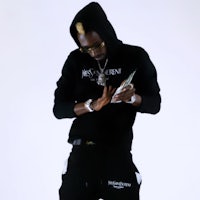 a man in a black hoodie holding a cell phone