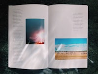 an open book with a photo of a farm and a lightning storm
