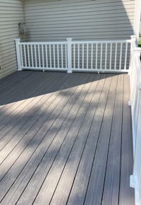 a deck with a white railing and white railing