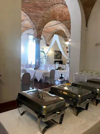 a banquet room with tables and silverware set up