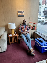 a man sitting on a chair in a room
