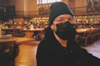 a person wearing a mask in a library
