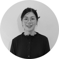 a black and white photo of a woman wearing glasses