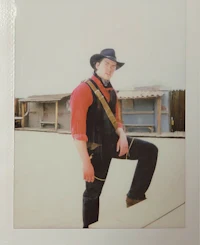 a man in a cowboy outfit posing for a photo