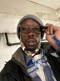 a man wearing glasses and a bandana