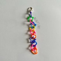 a rainbow loom bracelet on a white surface