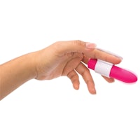 a woman's hand holding a pink toy on a white background