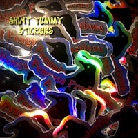 a pile of glow in the dark stickers with the words'shint tummy'