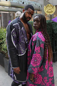 a man and woman standing next to each other in a purple and black outfit