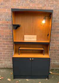 a black tv cabinet with a light on it