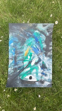a painting on the grass with a blue and green background