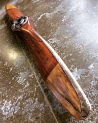 a wooden propeller laying on a concrete floor