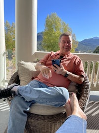 a man sitting in a wicker chair
