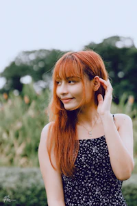 a woman with red hair is posing for a photo
