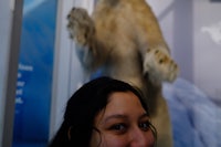 a woman smiling at a polar bear