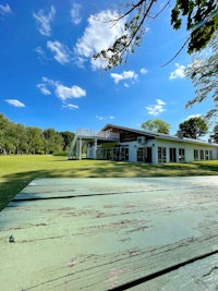 a view of a white house in a grassy field