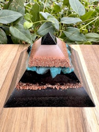 a pyramid with blue and black stones on top of it