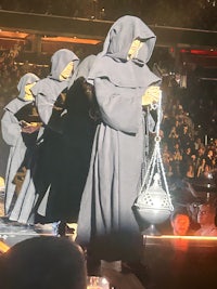 a group of monks standing on a stage