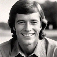a black and white photo of a young man smiling