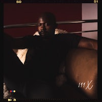 a man in a black shirt sitting on a couch