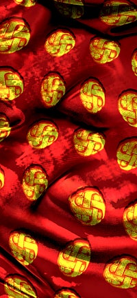 a red cloth with gold circles on it