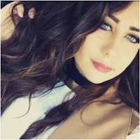 a woman with long brown hair is posing for a photo