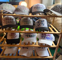 a rack of hats with different words on them