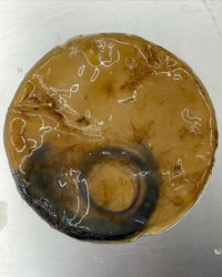 an image of a brown liquid on a plate
