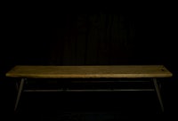 a wooden bench against a black background