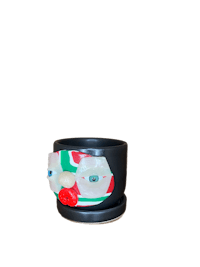 a black pot with a face on it