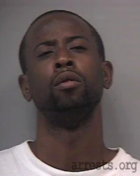 a mug shot of a man in a white shirt