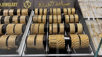 a display of gold bracelets in a jewelry store