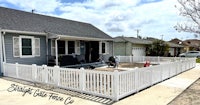 a white picket fence in front of a house