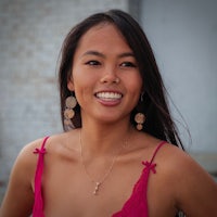 asian woman wearing a pink top and earrings