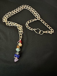 a multi - stone necklace with a gold chain