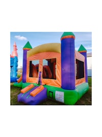 a purple and orange bounce house with a slide