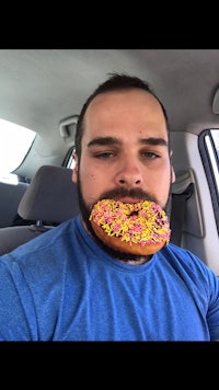 a man with a donut in his mouth