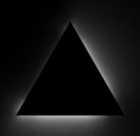 a black and white photo of a triangle in a dark room
