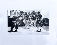 a black and white photograph of people walking down a street