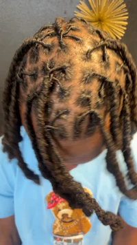 a little girl with dreadlocks in her hair