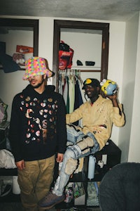 two men standing next to each other in a room