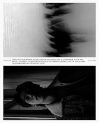 a black and white image of a man standing in front of a window