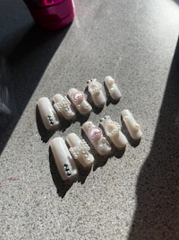 a group of white nail polishes on a table